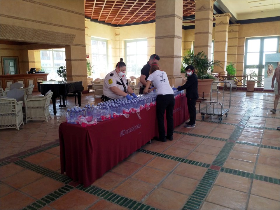 Employees arrange water bottles in the lobby for worried guests amid the coronavirus scare