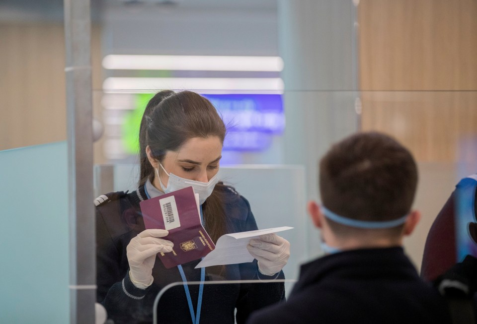 Airport worker checks a passport using a face mask in Moldova due to the coronavirus outbreak