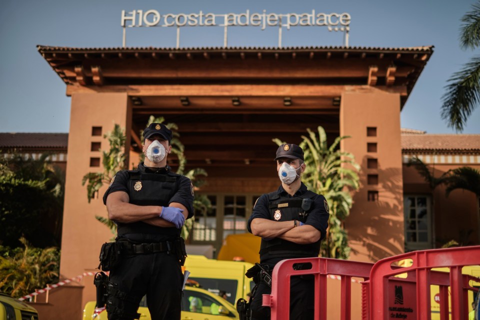 Spanish cops stand outside the hotel after two more cases of the virus have been confirmed