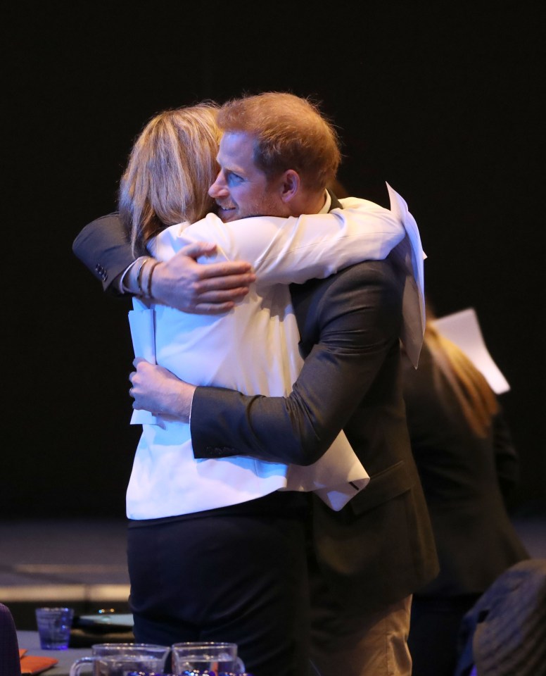  Prince Harry hugs one of the guests before the event to promote Travalyst