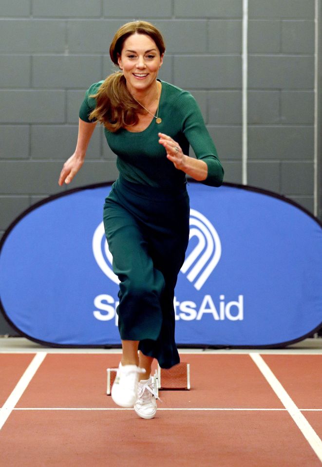  Kate Middleton beams as she races down the track during a trip to the London Stadium today