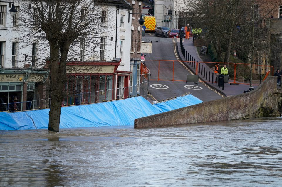  Flood barriers are overwhelmed by water from the River Severn in Ironbridge, England