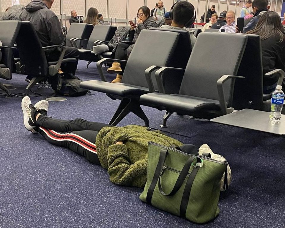  A woman has divided opinion after blocking two airport seats while napping