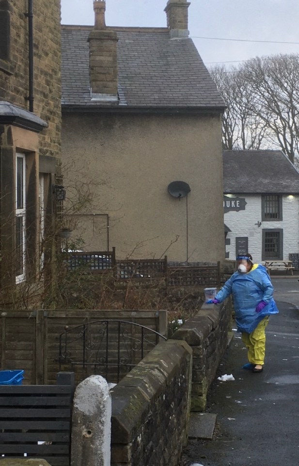  Medical staff in protective clothing call at a property close to the Buxton school involved in the latest case of coronavirus