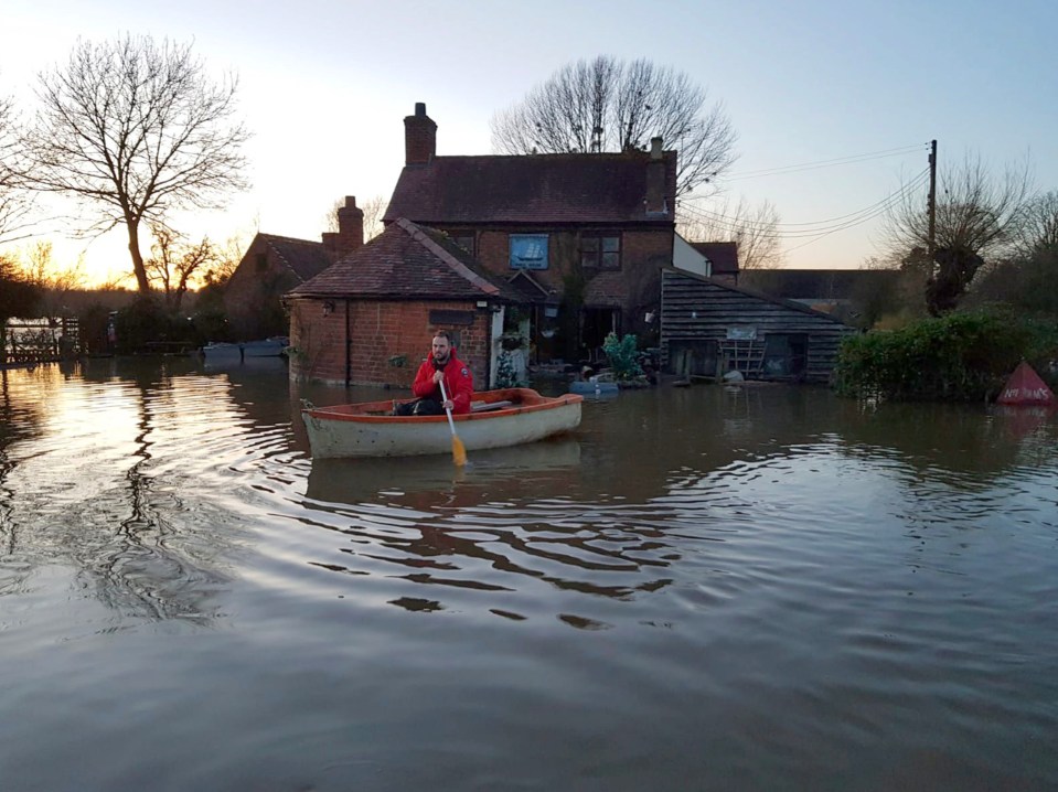  Landlord Mark Fox has been forced to row around his pub due to flooding in Ashleworth, Gloucs