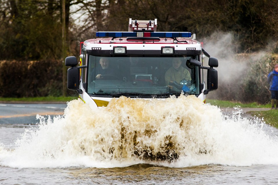  A fire engine powers through flood water in East Cowick