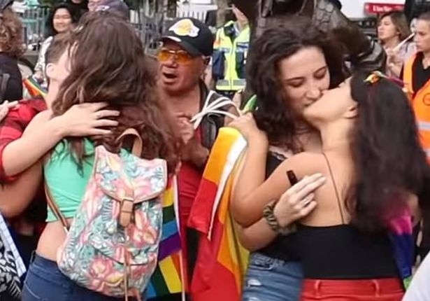  Other lesbian couples were also filmed kissing as the preacher shouted his religious beliefs on a megaphone