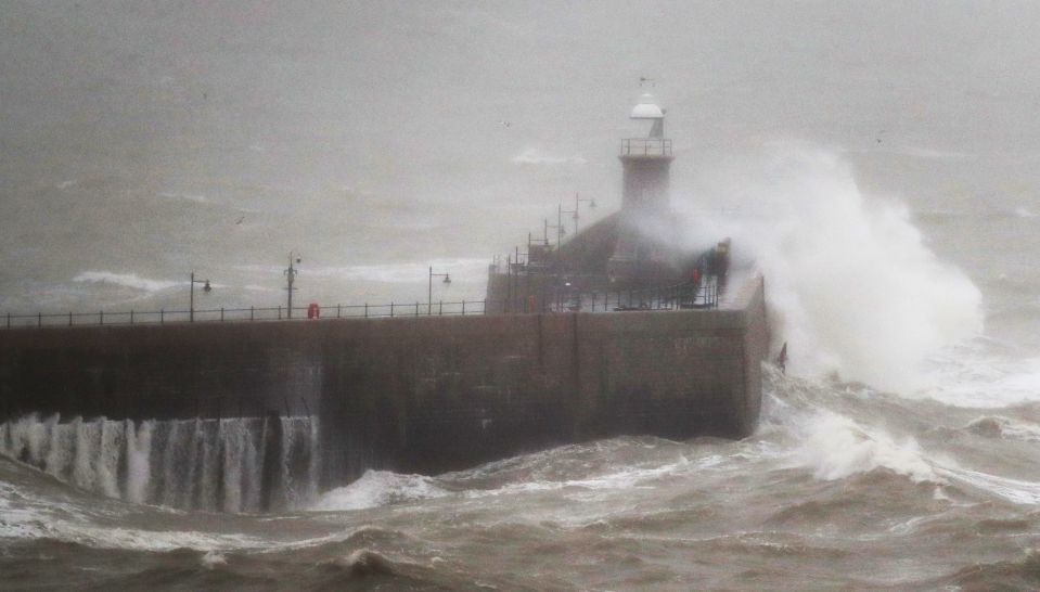  Large waves crash over the harbour wall in Folkestone, Kent