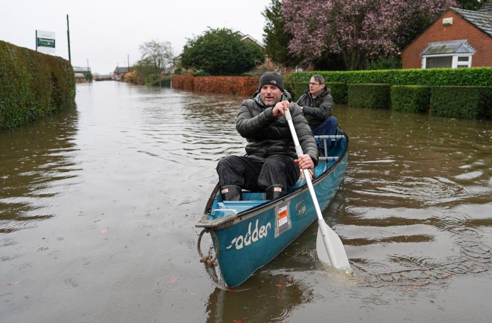  Residents canoe from their homes along a flooded street after the River Aire bursts its banks in Snaith, East Yorks