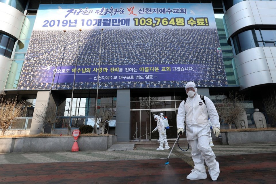  A man sprays disinfectant in front of the Shincheonji Church of Jesus in Daegu, South Korea