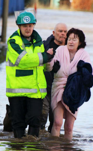  A resident is rescued from flood waters in Bury, Gtr Manchester