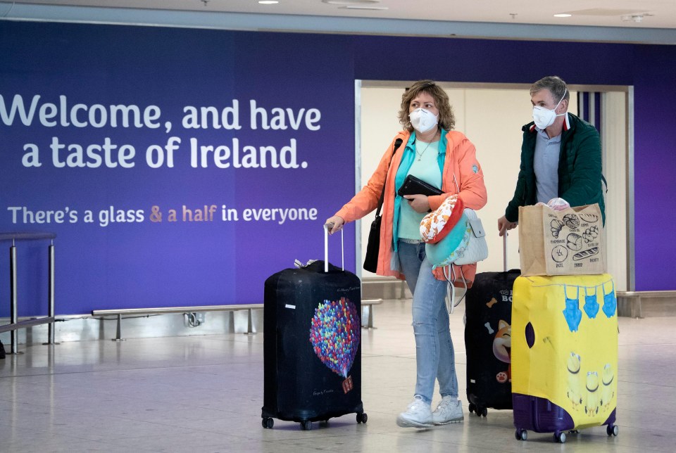  Passengers wearing face masks arrive at Dublin Airport this afternoon after disembarking flights