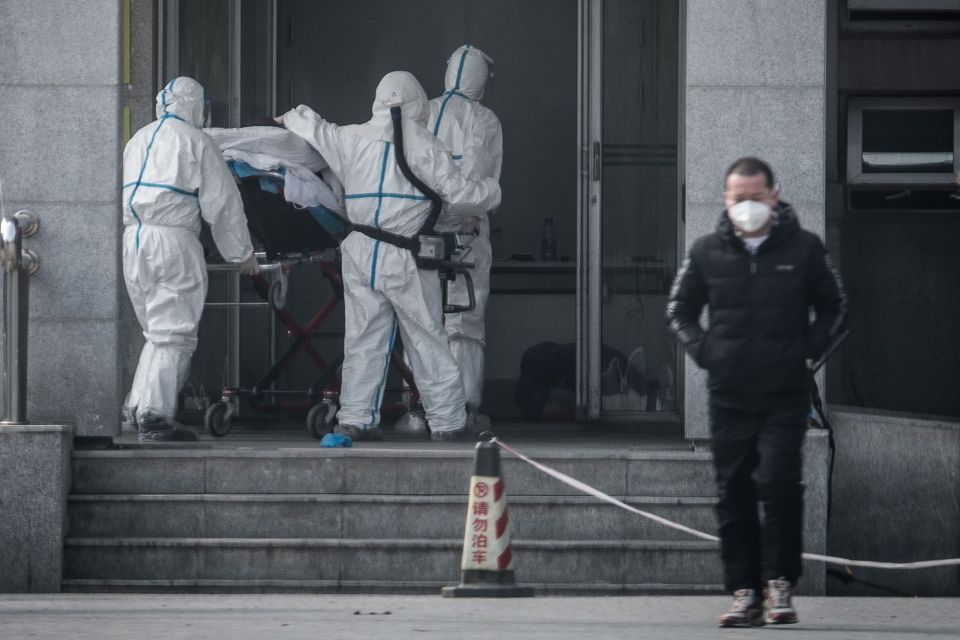  Medical workers carry a patient to a hospital in Wuhan