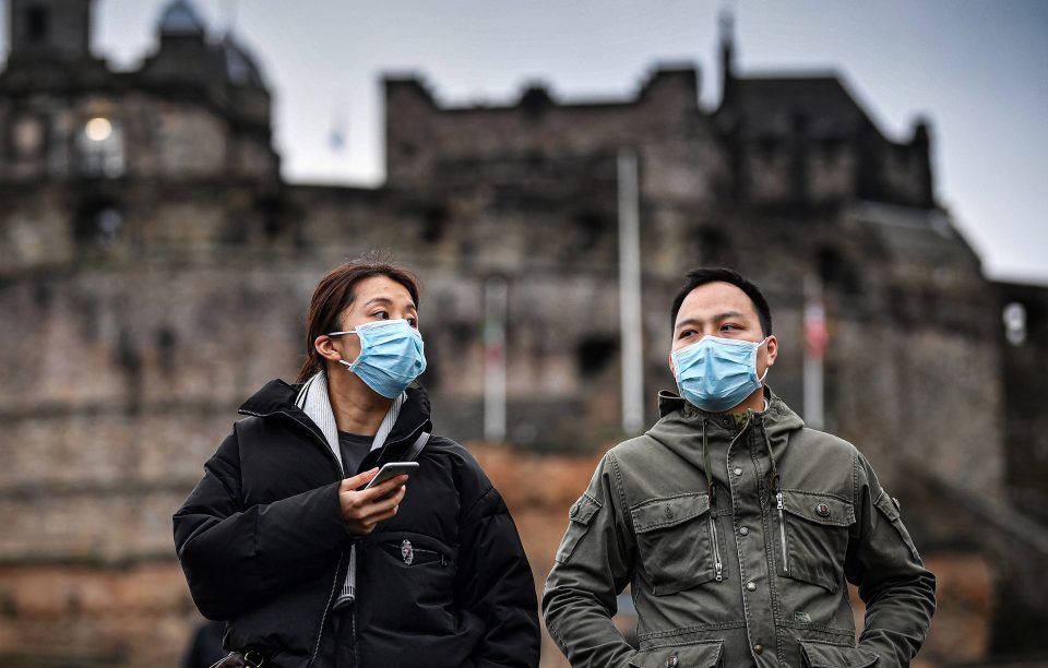  A couple wear face masks outside Edinburgh Castles as cases of coronavirus in the UK continue to soar