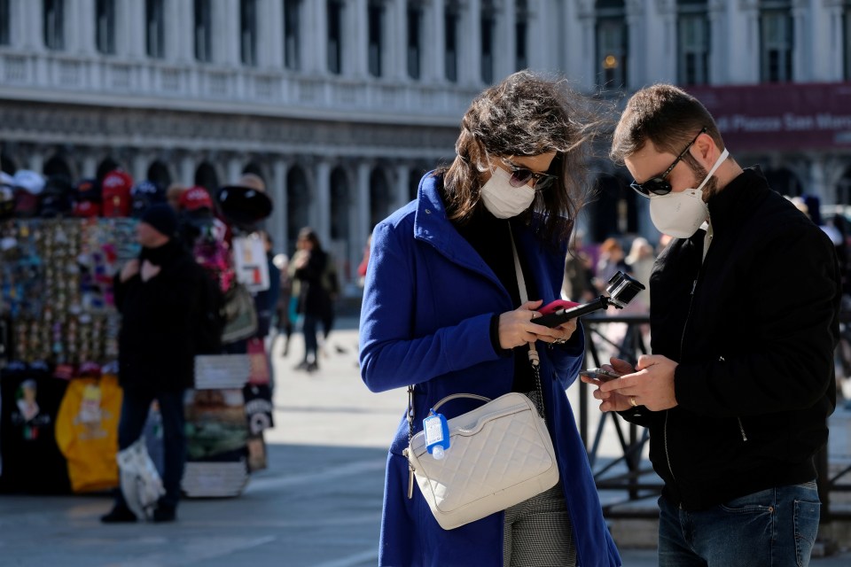  Tourists wear protective masks in Saint Mark's Square in Venice