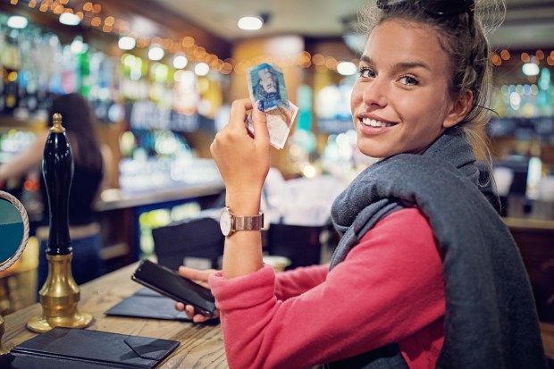 Woman with cash at pub bar