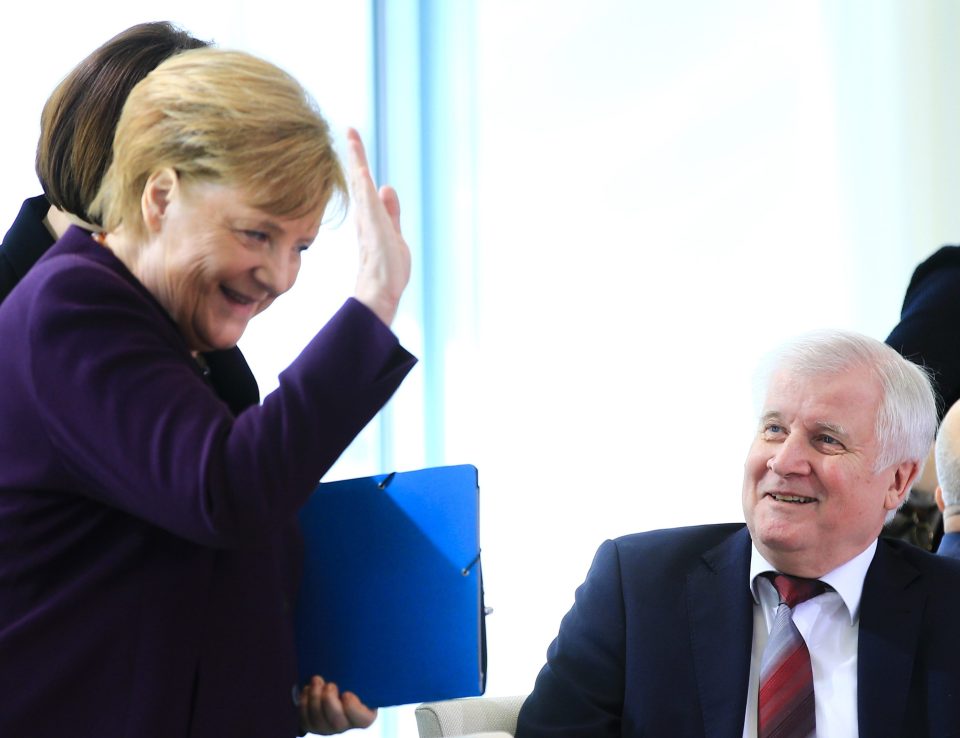  Angela Merkel jokes as she refuses to shake hands with other ministers