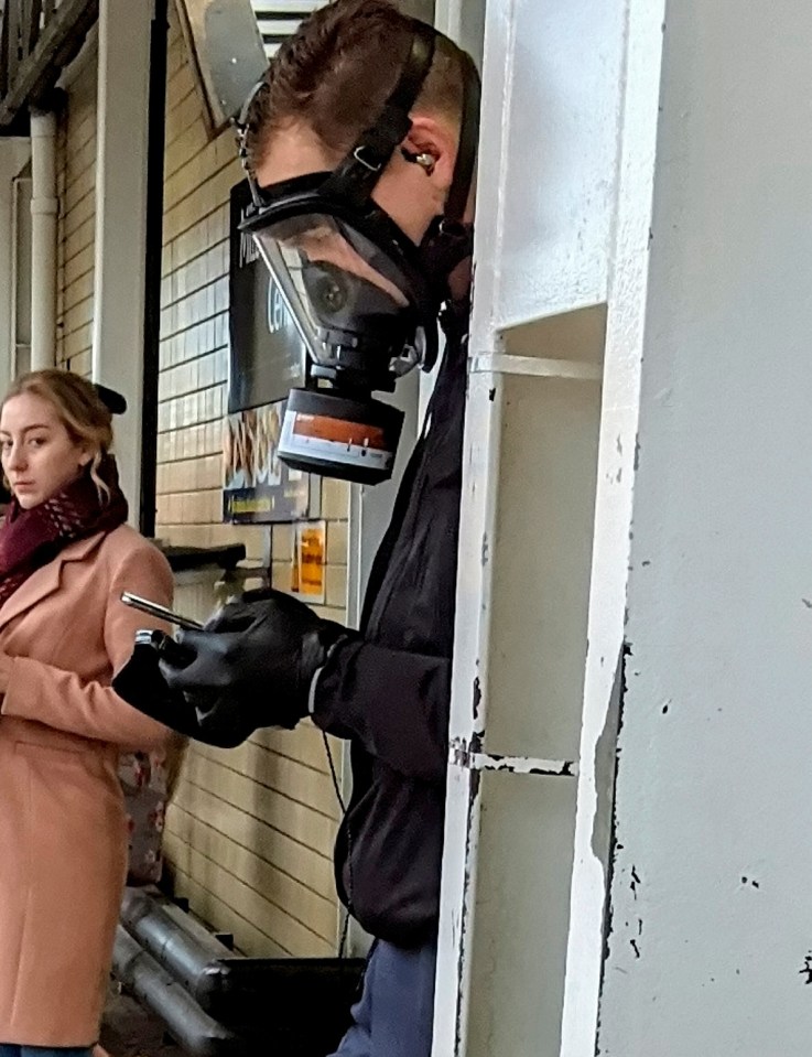  A man waits at a busy train station wearing a gas mask - as fears of coronavirus spread