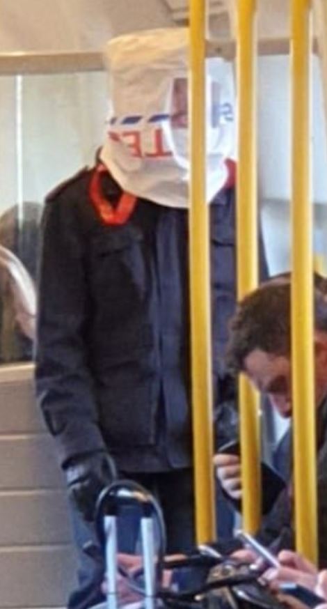  One passenger in London wears a plastic bag on his head