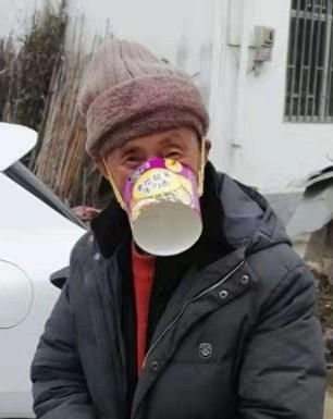  A man covers his mouth with a cup