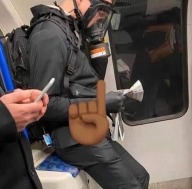  A Londoner sports a gas mask on the tube