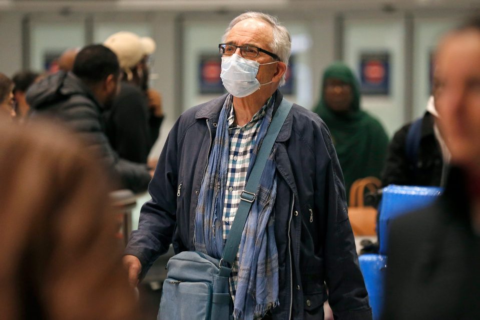  A man wears a mask while at Roissy Charles de Gaulle airport