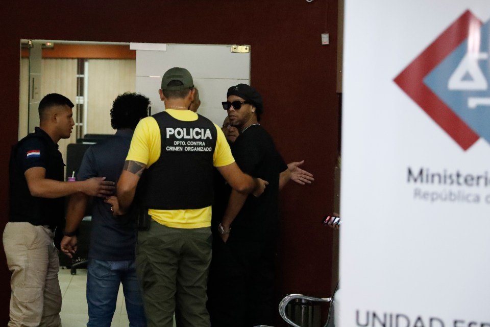  Ronaldinho and his brother are taken inside by Paraguayan authorities