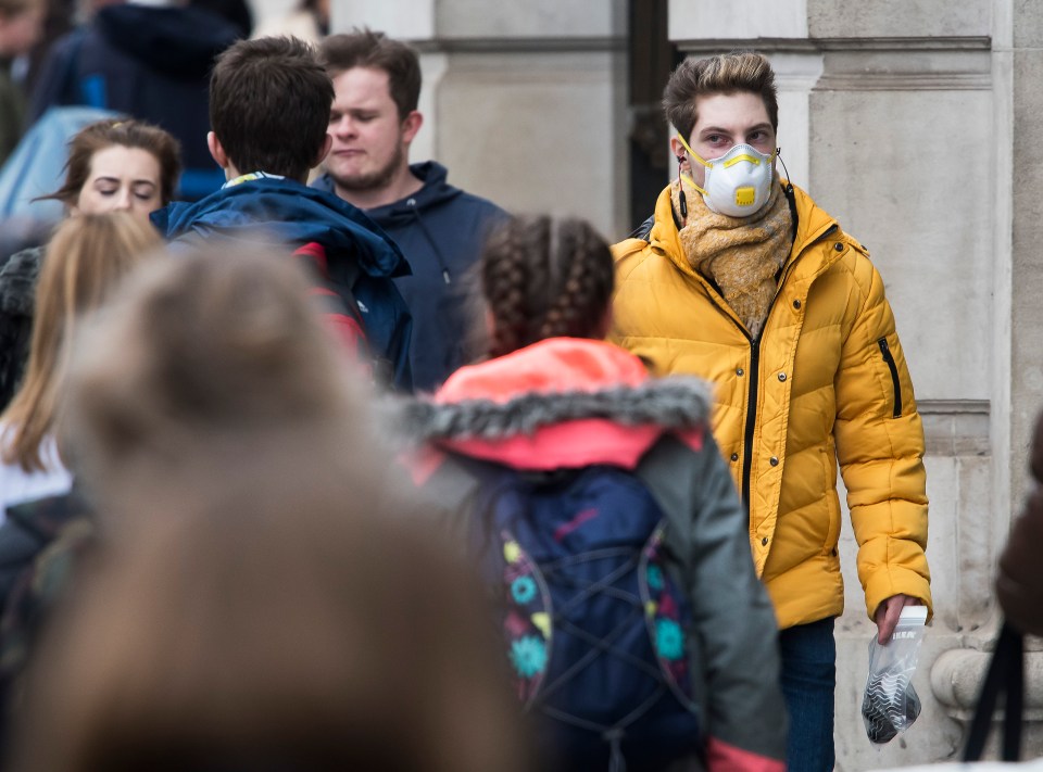  A shopper on Oxford Street wears a medical mask