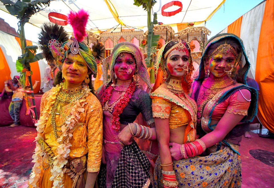 Revellers cover themselves in paint to celebrate Holi