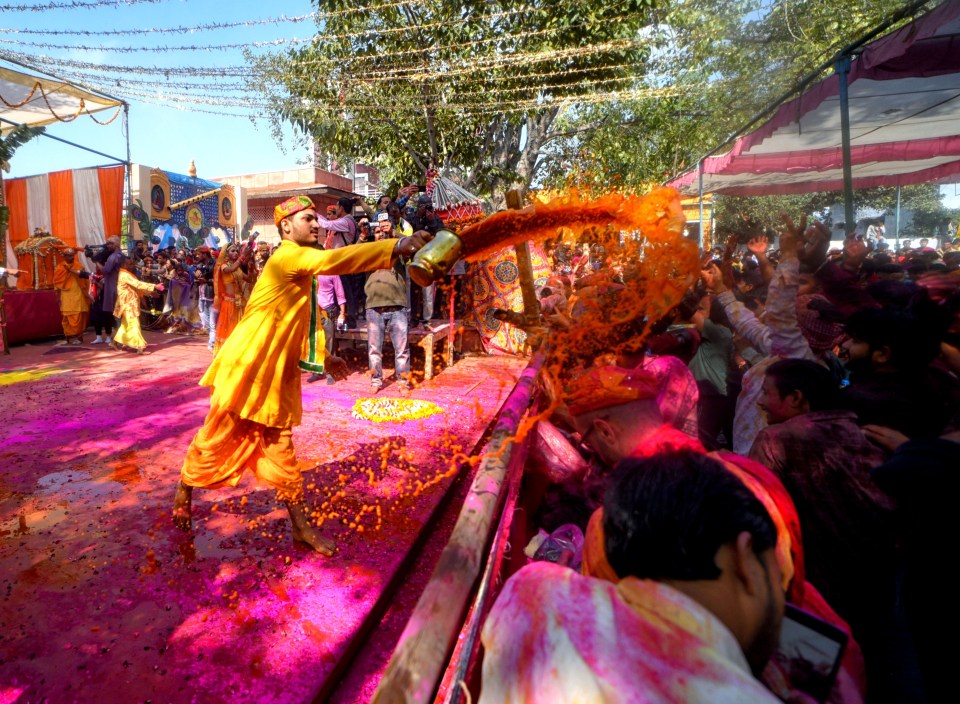 People celebrate Holi by throwing paint on each other