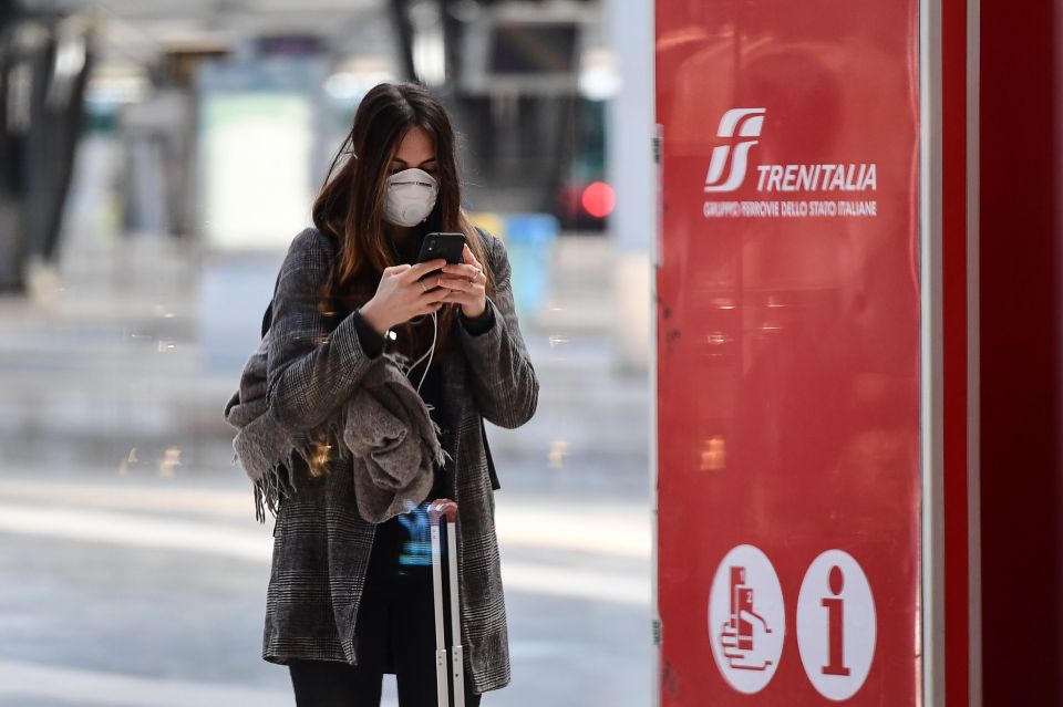  Passengers, some wearing protective face masks, wait in Milano Centrale railway station in Milan after millions of people were placed under forced quarantine in northern Italy