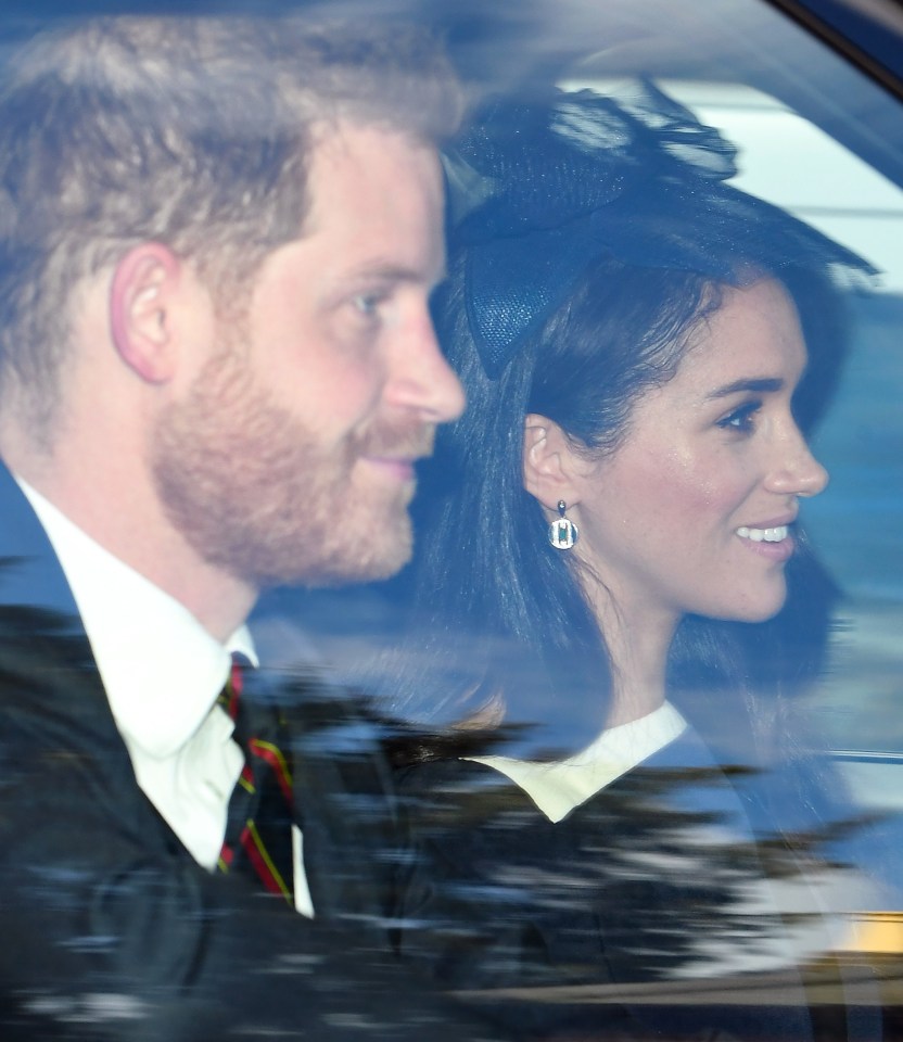  Prince Harry smiles as he drives into church with wife Meghan Markle