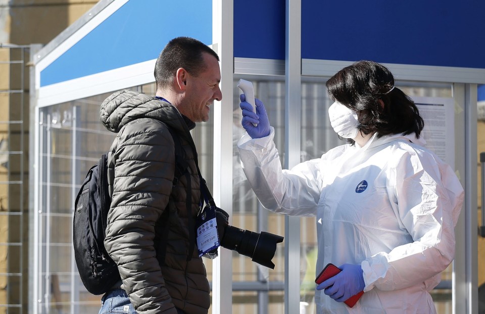 An operator performs anti-coronavirus check ahead of Parma’s game against Spal