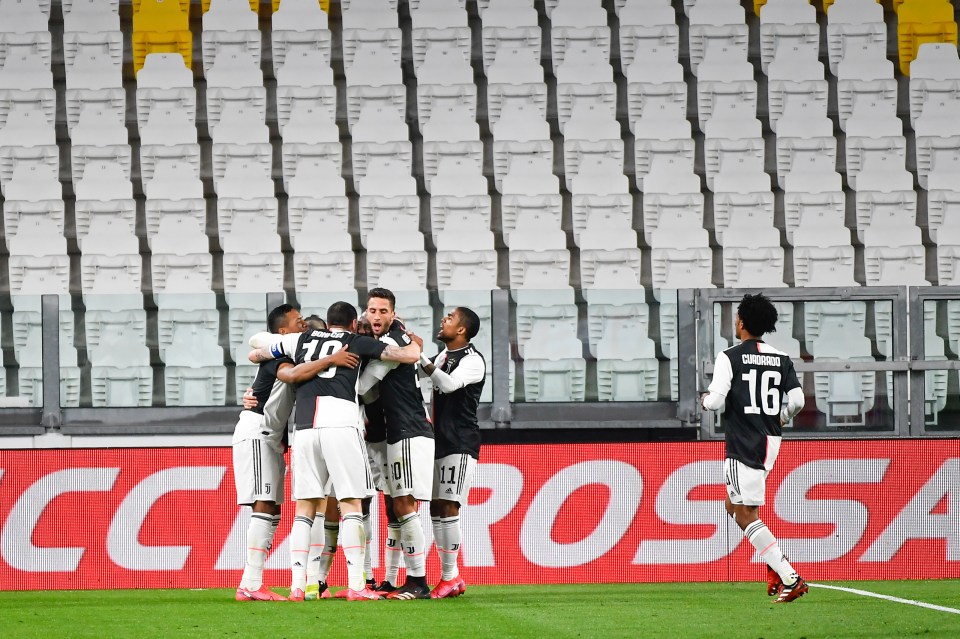  Juventus players celebrate Aaron Ramsey's opening goal in front of an empty stadium