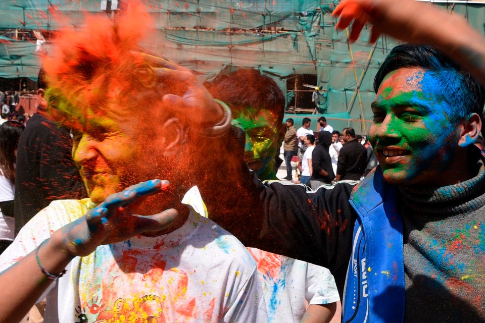 Festival-goers indulging in the paint-throwing activities on Holi