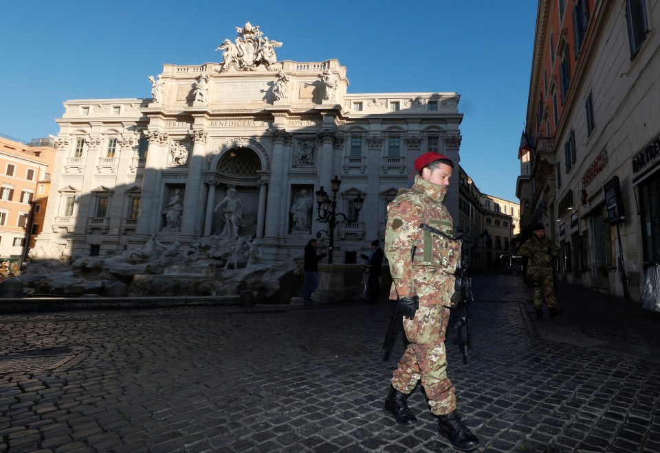  Military members patrol the Trevi fountain in Rome which is virtually deserted as Italy fights a coronavirus outbreak