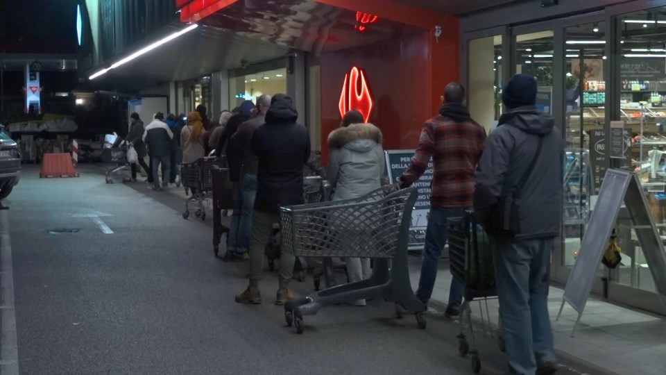  People queue outside a shop in Rome after the lockdown announcement