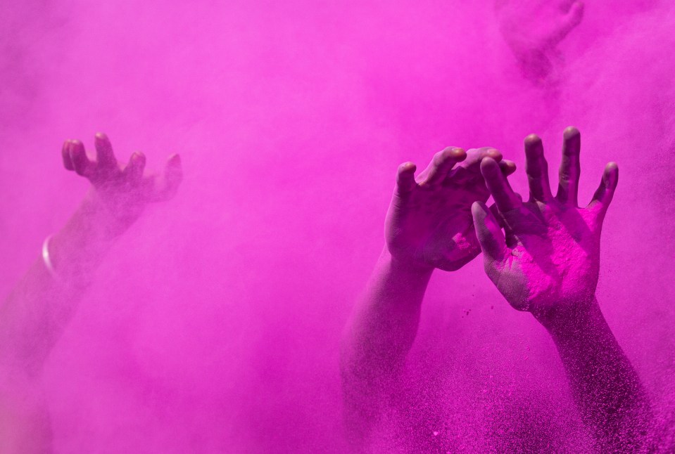 Revellers dance and throw coloured powder in Gauhati, India to commemorate the arrival of spring