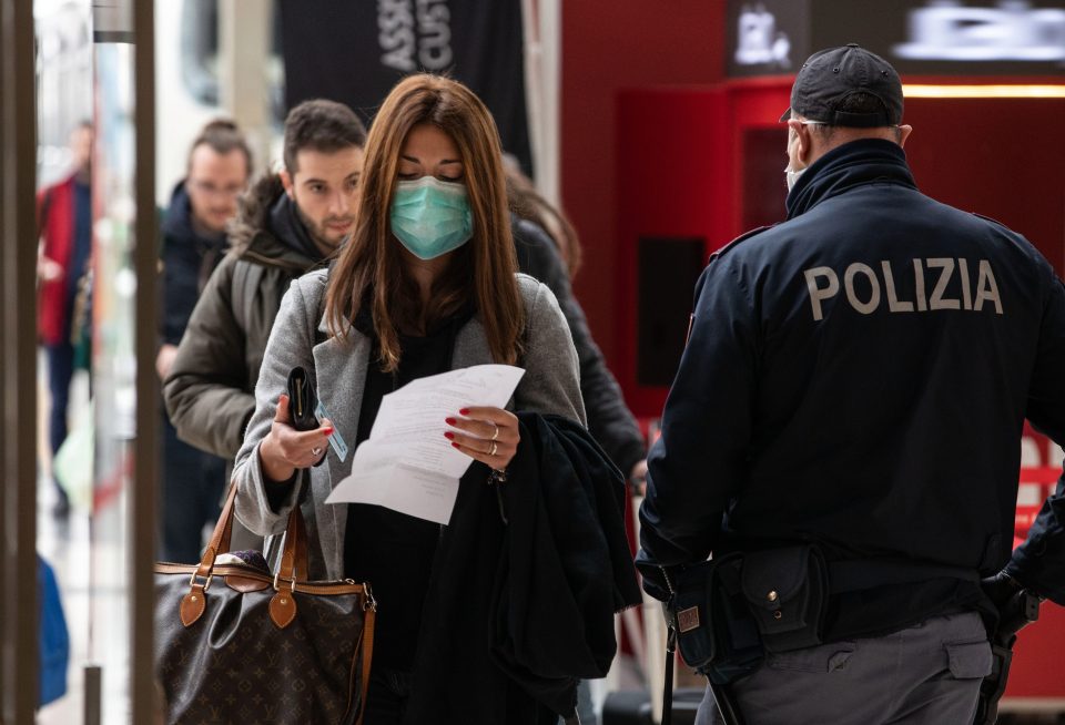  A woman wears a surgical mask as in Italy as the country has gone into lockdown over the number of coronavirus cases continues to soar