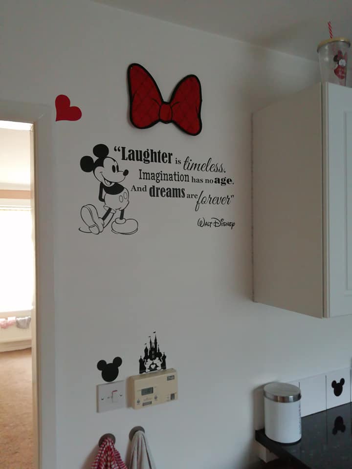  The walls were splatted with iconic Disney quotes, and small Mickey themed stickers that lined the crisp white skirting and tiles