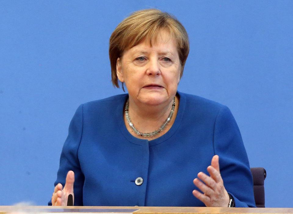  German Chancellor Angela Merkel addresses journalists at a press conference on the development of the coronavirus on Wednesday