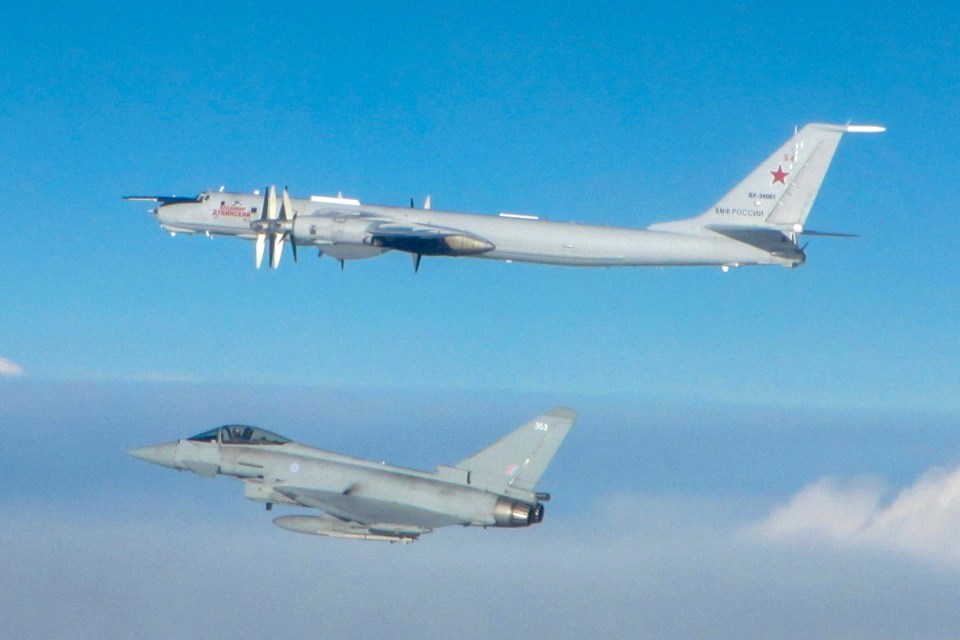  An RAF Typhoon FGR4 jet flies underneath a Russian Tu-142 Bear stalking British skies