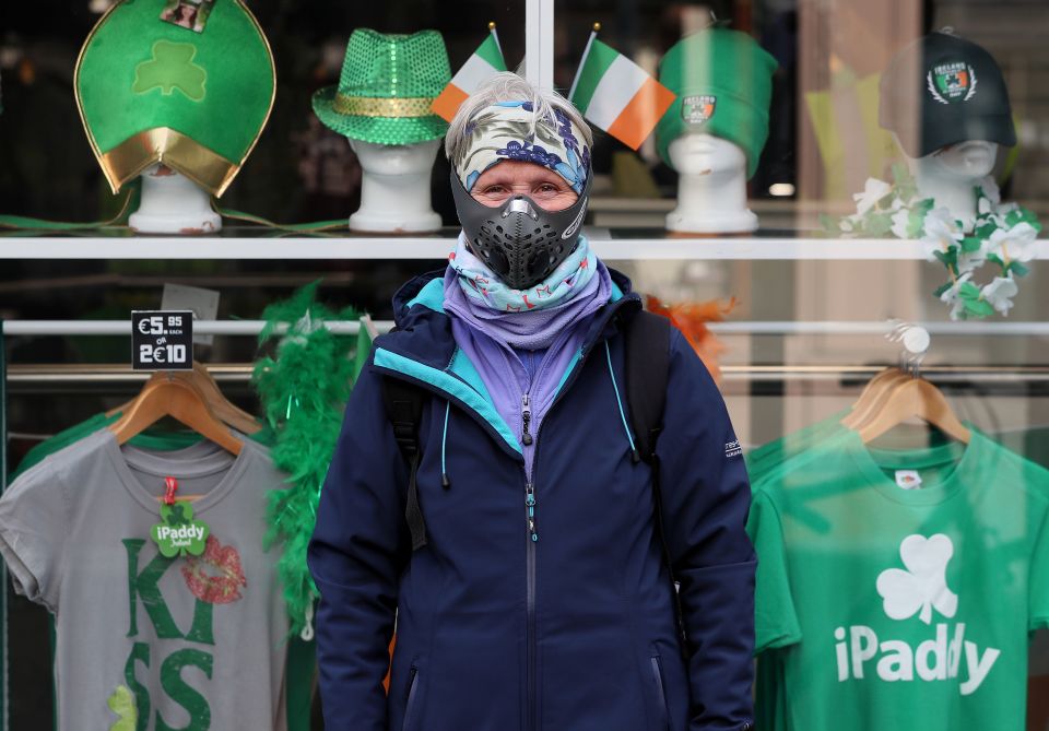  A woman from Dublin poses with a mask as Ireland braces for a two-week shutdown of public buildings, including schools, colleges and tourist sites