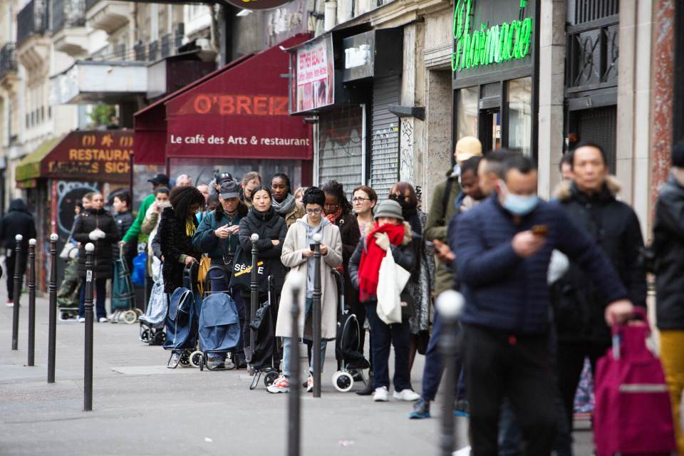  People wear masks while waiting to get into Lidl in Paris