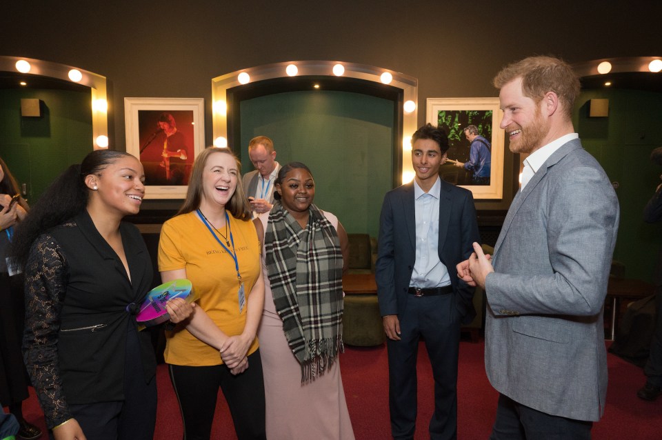  Prince Harry laughs with Latoya McLean, a founding member of the groundbreaking youth centre Unitas in North London