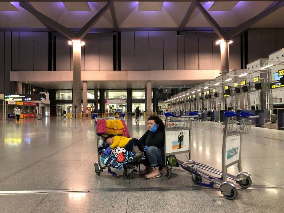  Woman with her daughter wait for their flight from Spain today