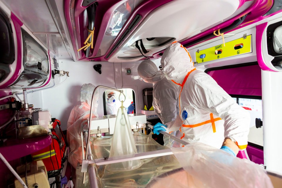  Medical workers in protective suits monitor a coronavirus patient who is being transferred in an ambulance from the intensive care unit of the Gemelli Hospital to the Columbus Covid Hospital