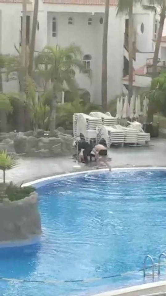  Meanwhile in Tenerife, a rebel holidaymaker is hauled from a closed pool after flouting the virus lockdown