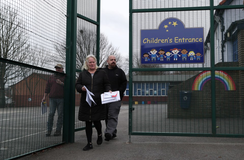  Parents leave Bullion Lane Primary School with homework after the school closed as the spread of the coronavirus disease (COVID-19) continues, in Chester-le-Street