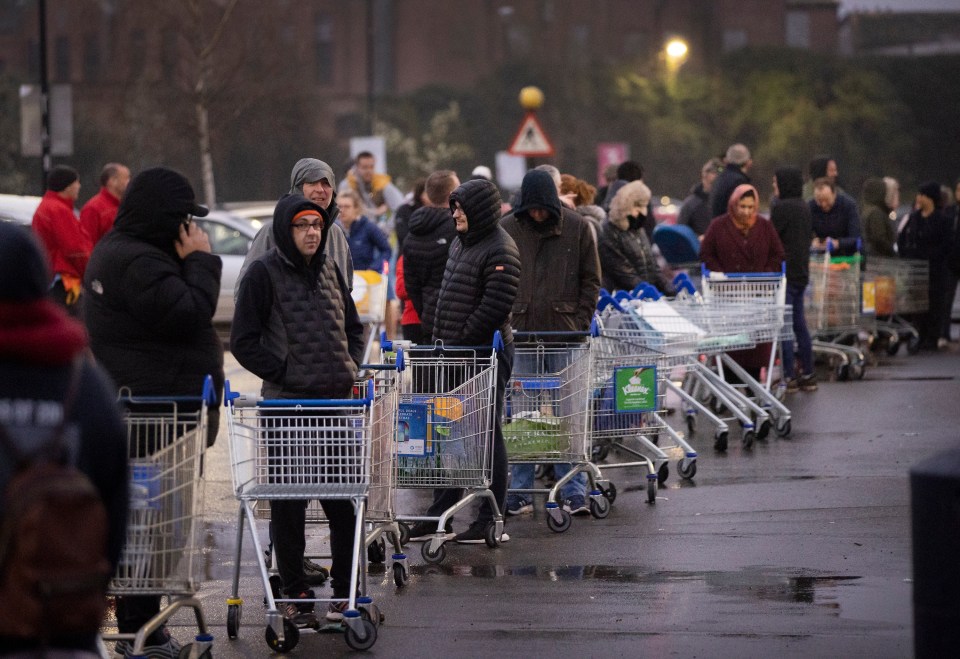  Desperate shoppers wait with their trolleys at 5am this morning